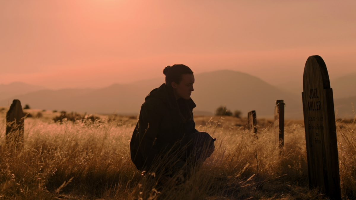 Ellie Williams (Bella Ramsey) kneels down at Joel Miller's grave. (Provided by HBO)