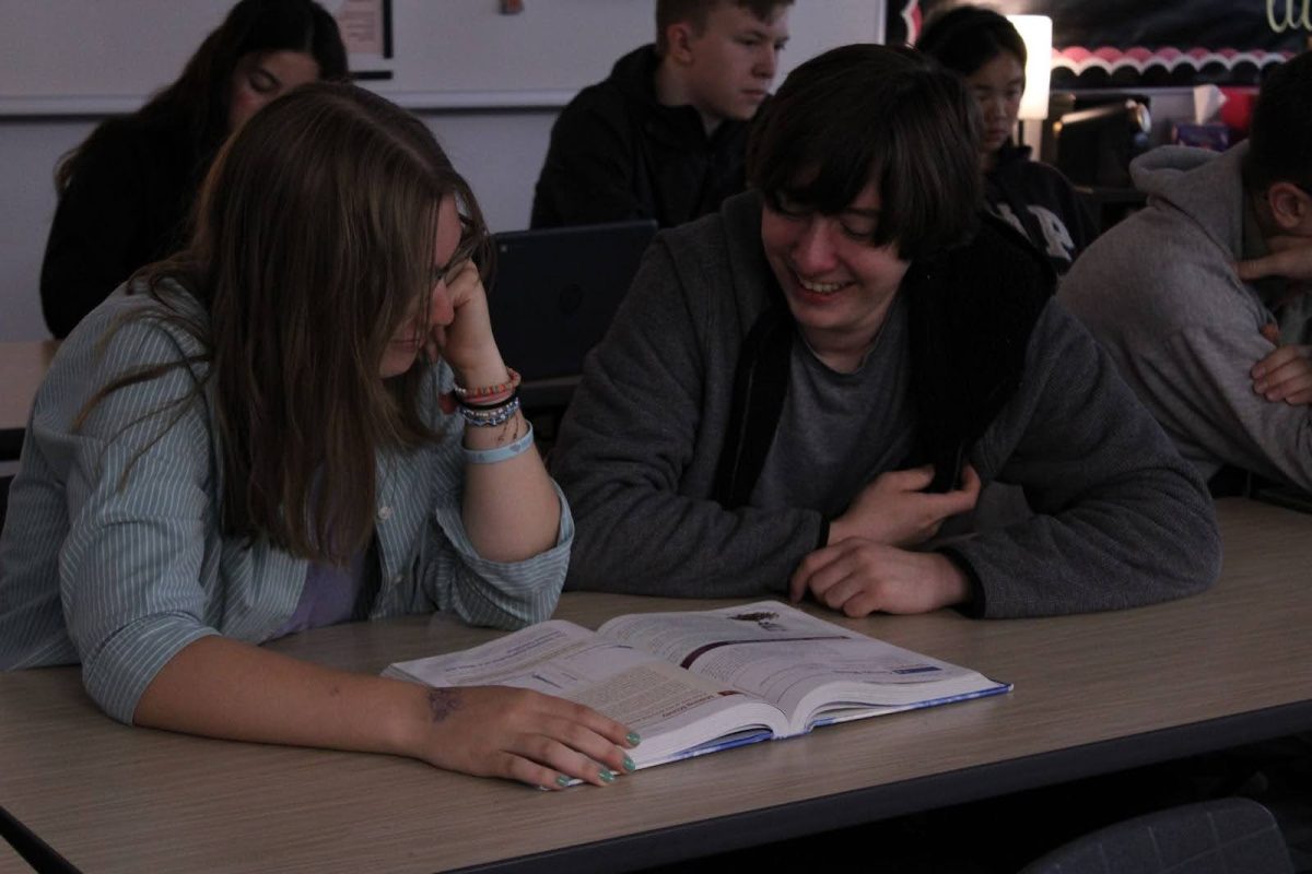 (Left to right) Students Eliza Fischer and Bo Wooll read over the AP Statistics textbook.