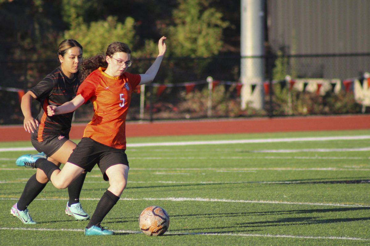JV player Leah Ngo (#7) guards C-team player Jocelyn Bellon (#5) as she passes the ball to a teammate.