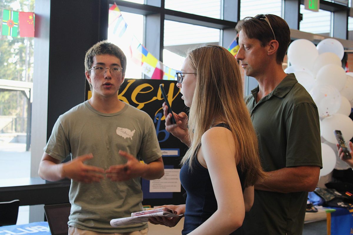 Kai Livingston (left) talks to guests (right) on Maze Day.