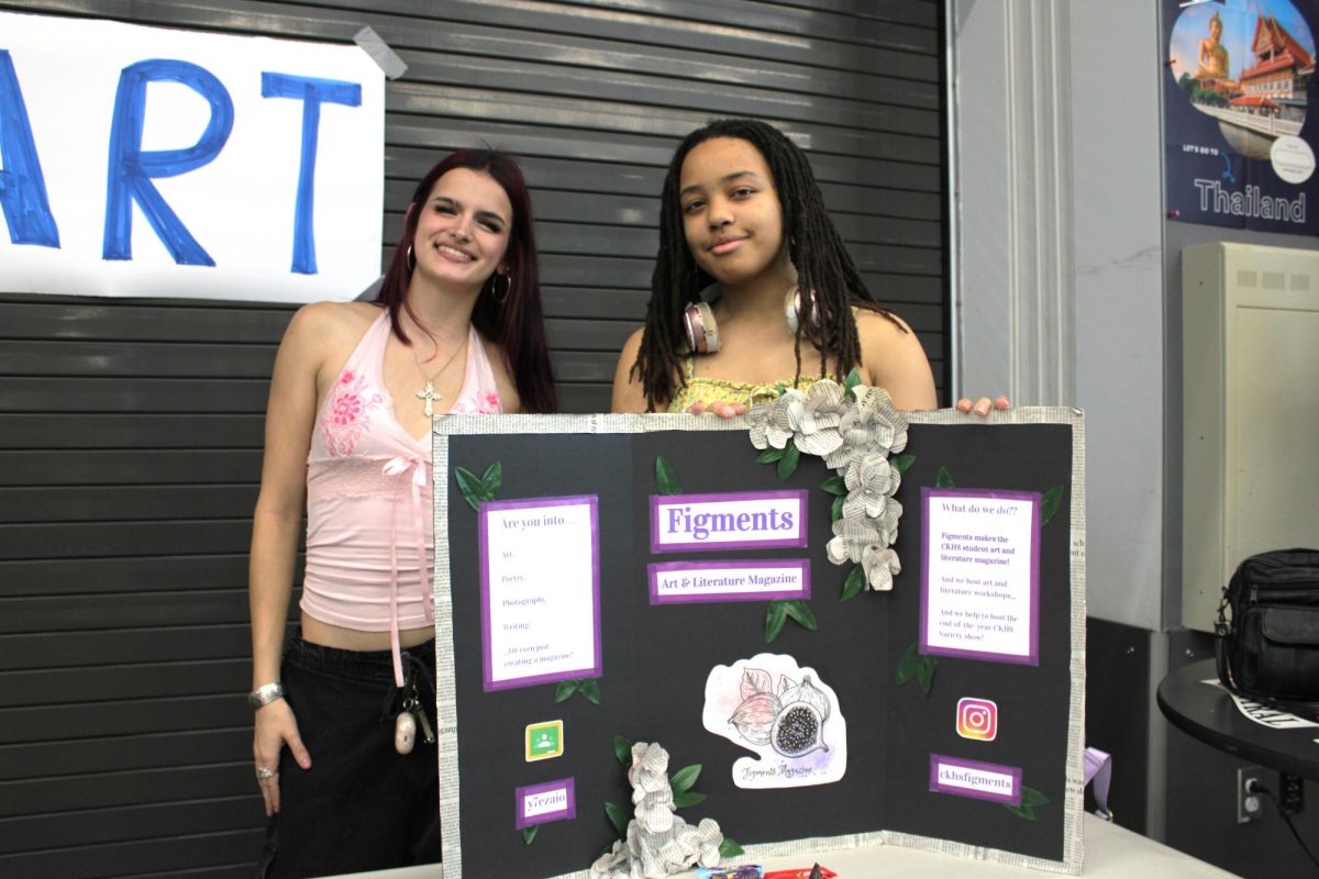 Madeline Johnson (left) and Taliya Getachew (right) stand behind their trifold.