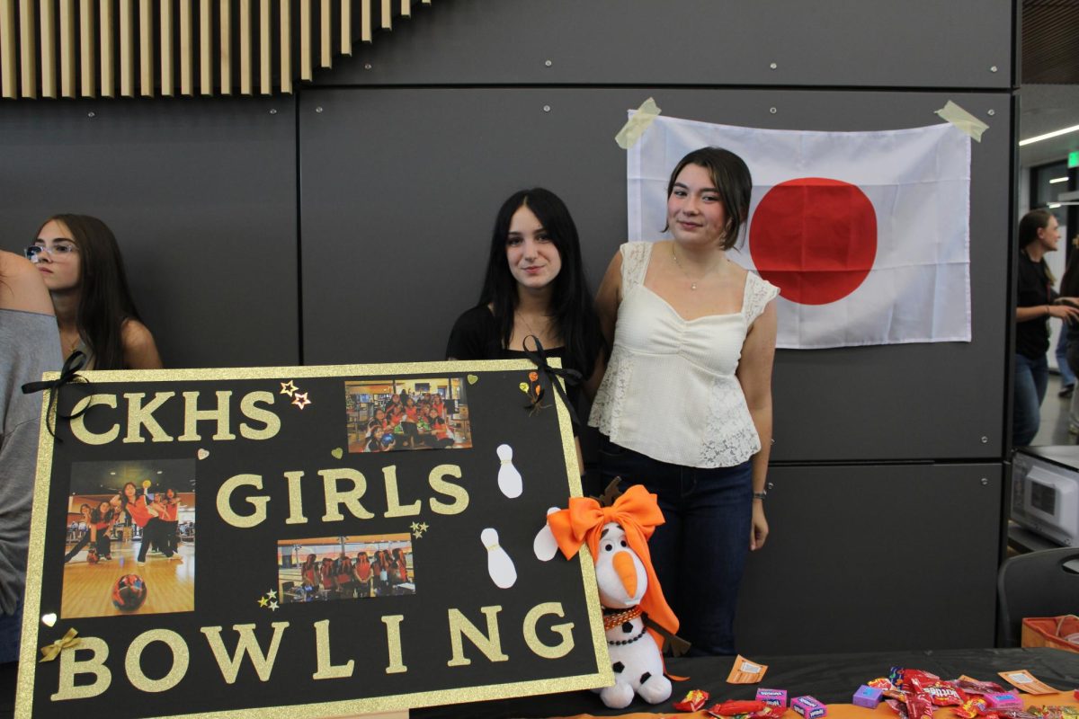 Jayden Whittington (left) and Caroline Peters (right) pose behind their trifold.