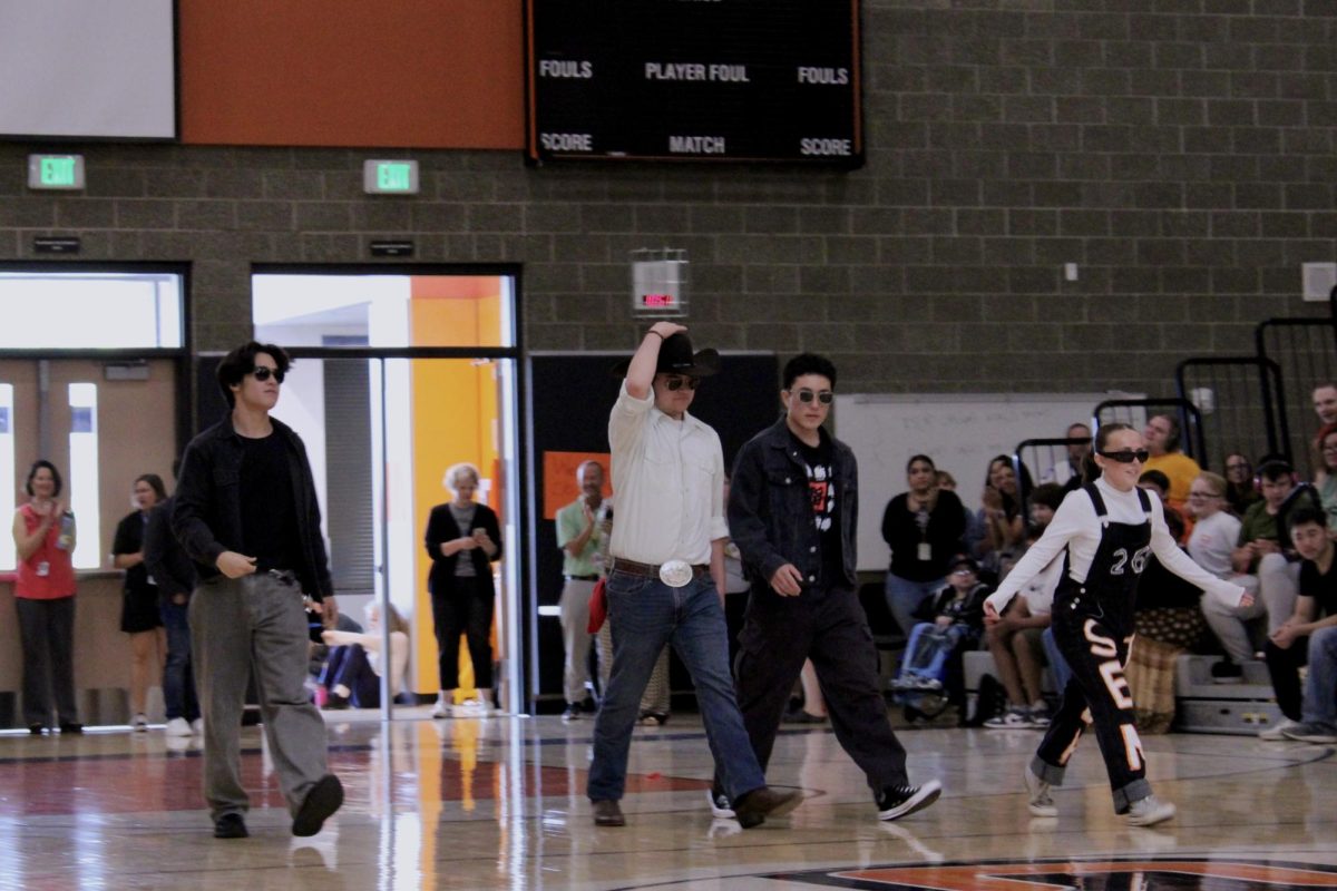 Nicholas Brazier (left), Lucas Smith (left center), Kai Livingston (right center), and Emily West (right) walk in for their introductory dance.