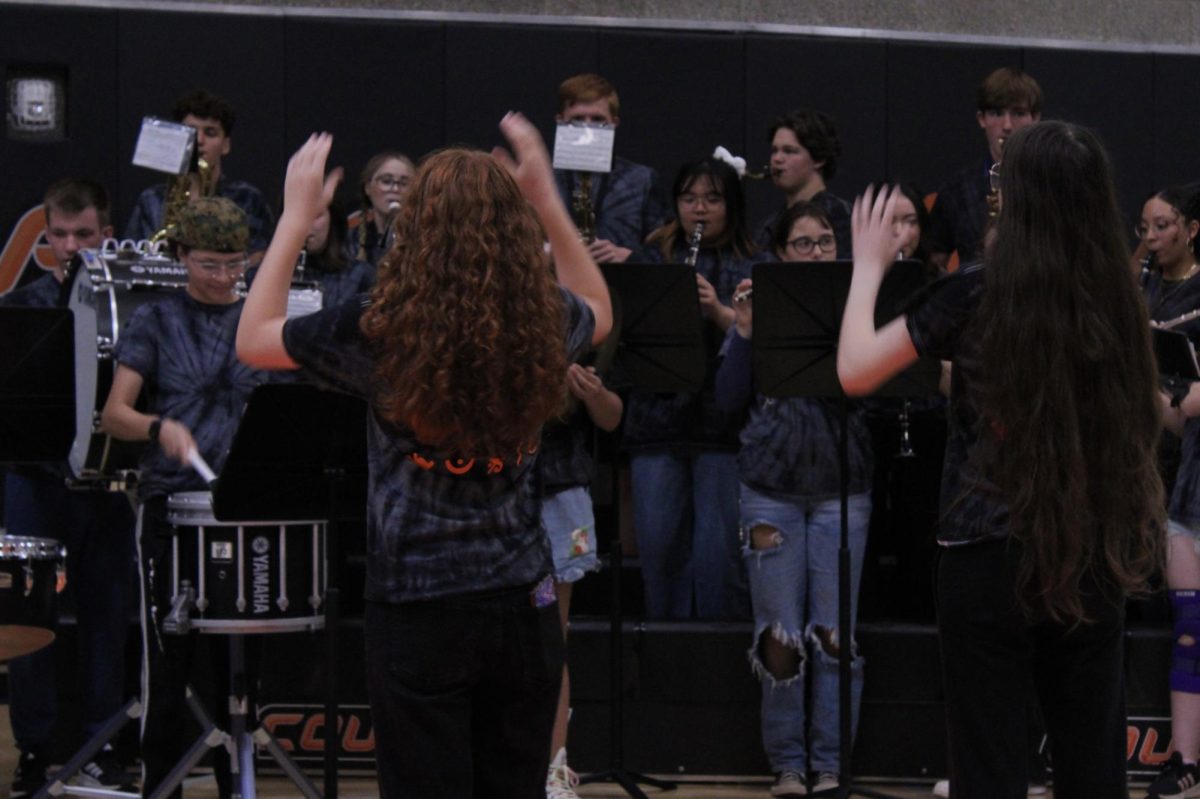 Lexie Durban (left) and Elliana Eagan (right) conduct the CKHS band.
