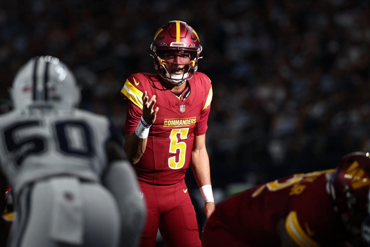 Washington Commanders quarterback Jayden Daniels (5) calls a play at the line of scrimmage against the Dallas Cowboys.