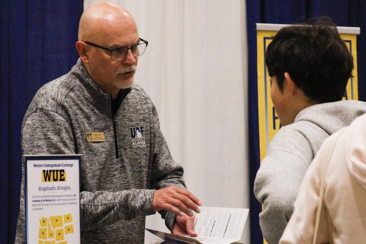 A student attending the National College Fair in Seattle connects with a college representative during the event.