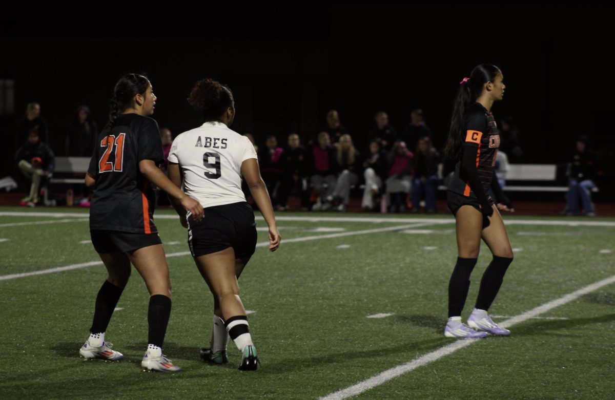 Senior midfielder #21, Yosselin Escobar-Moreno and senior captain midfielder #10, Maleia Dayao block off a Lincoln High player.