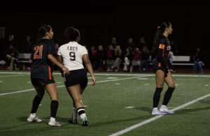 Senior midfielder #21, Yosselin Escobar-Moreno and senior captain midfielder #10, Maleia Dayao block off a Lincoln High player.