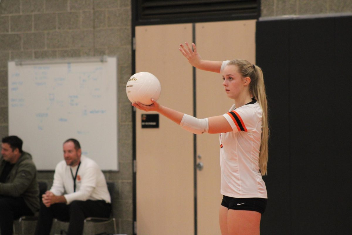 Penelope Holyoak (#7) prepares to serve the ball to Mount Tahoma High School.
