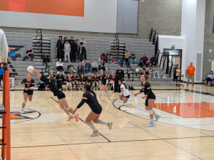 The CKHS players rush to get the ball back over the net.