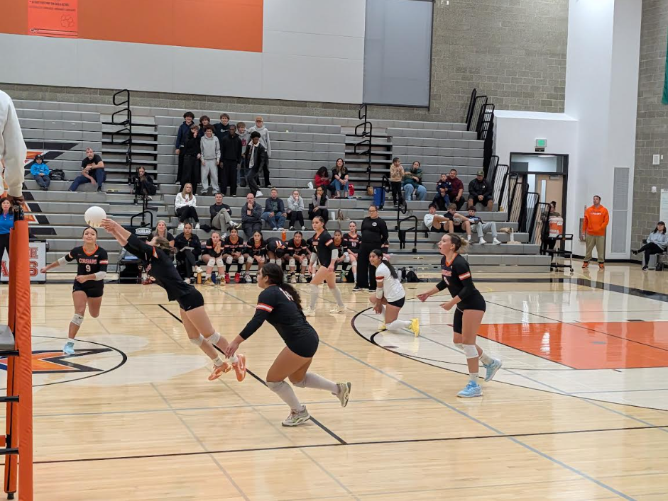 The CKHS players rush to get the ball back over the net.