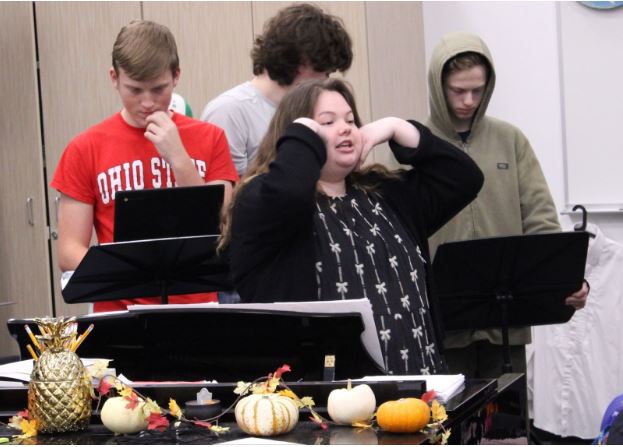 Calia Stodden shows choir students a warm-up before class.