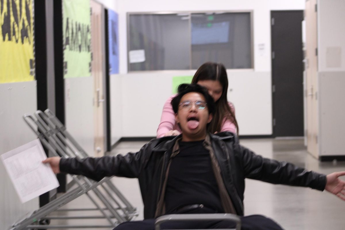 Juancho Perez being pushed around by Hannah Escamilla in the band hallway 