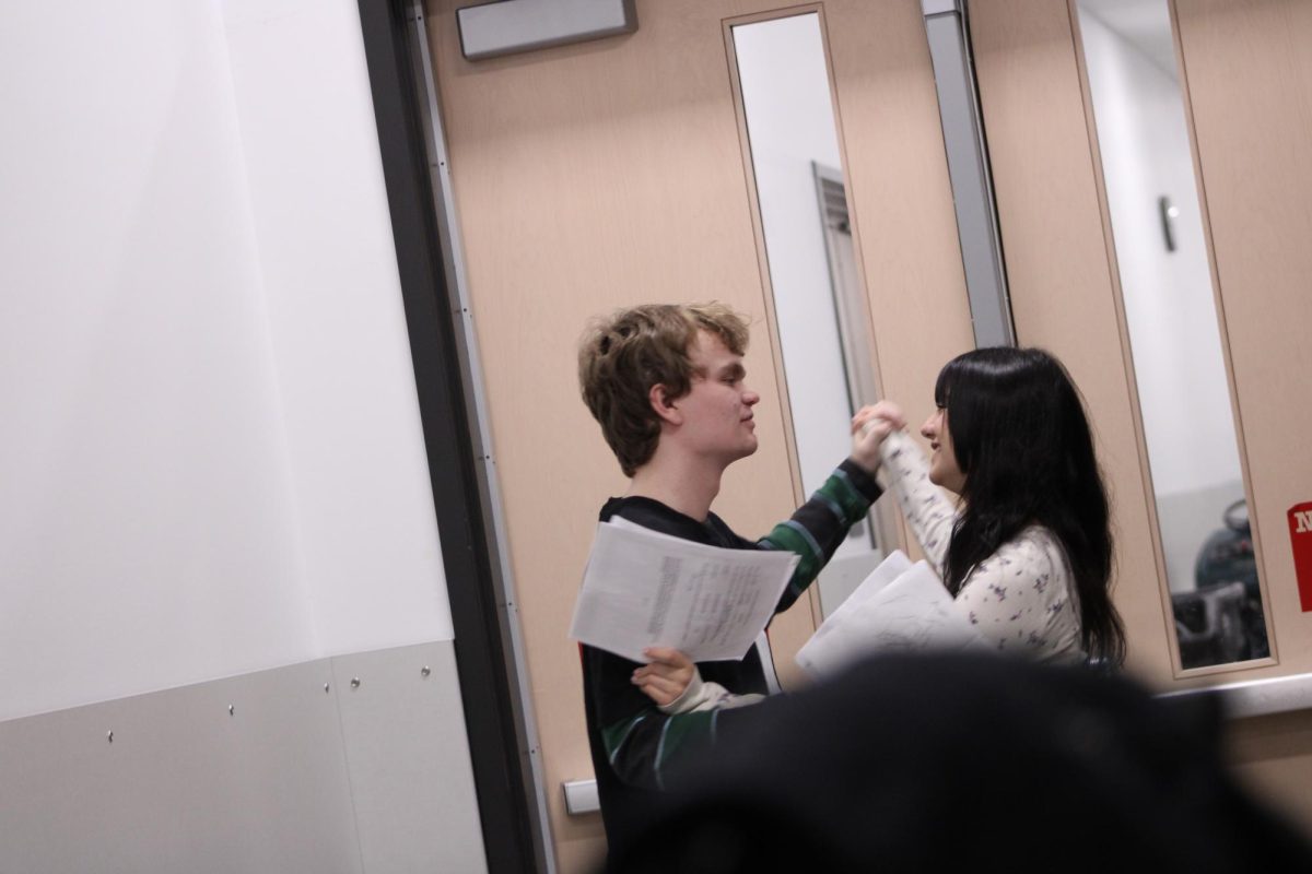 Henry Kosi  and Lola Lucero dancing in the band hallway during the dance in the script