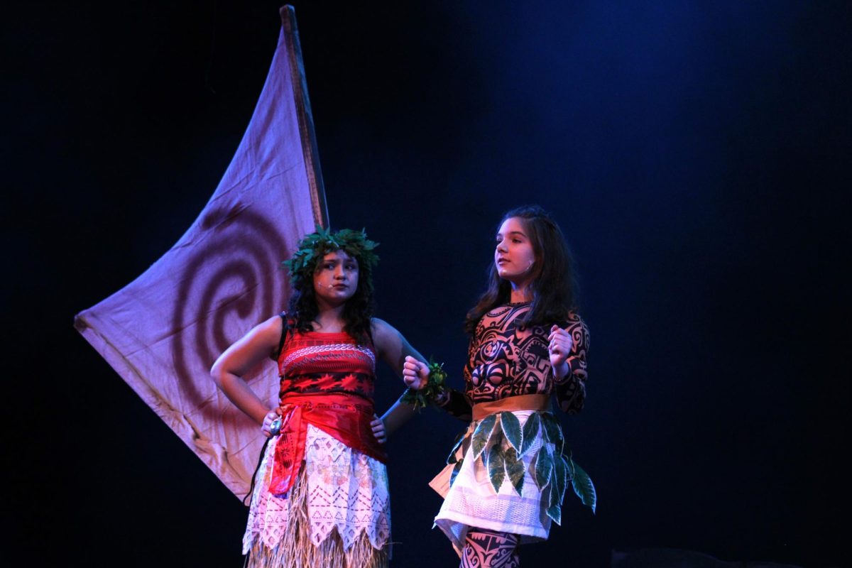 Isella Vincent (left) playing Moana stands next to Frances Burbank (right) playing Maui.