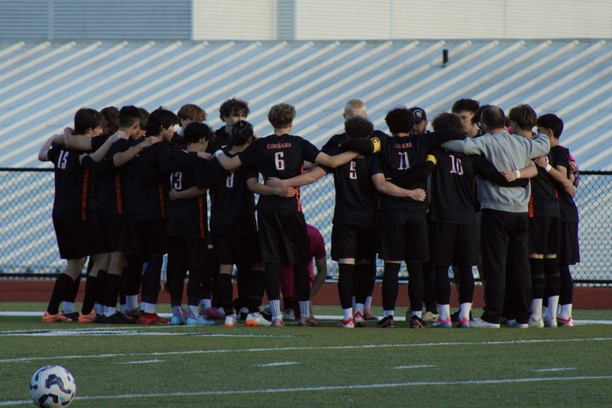 Boy's Varsity Soccer team huddles up before the game begins.