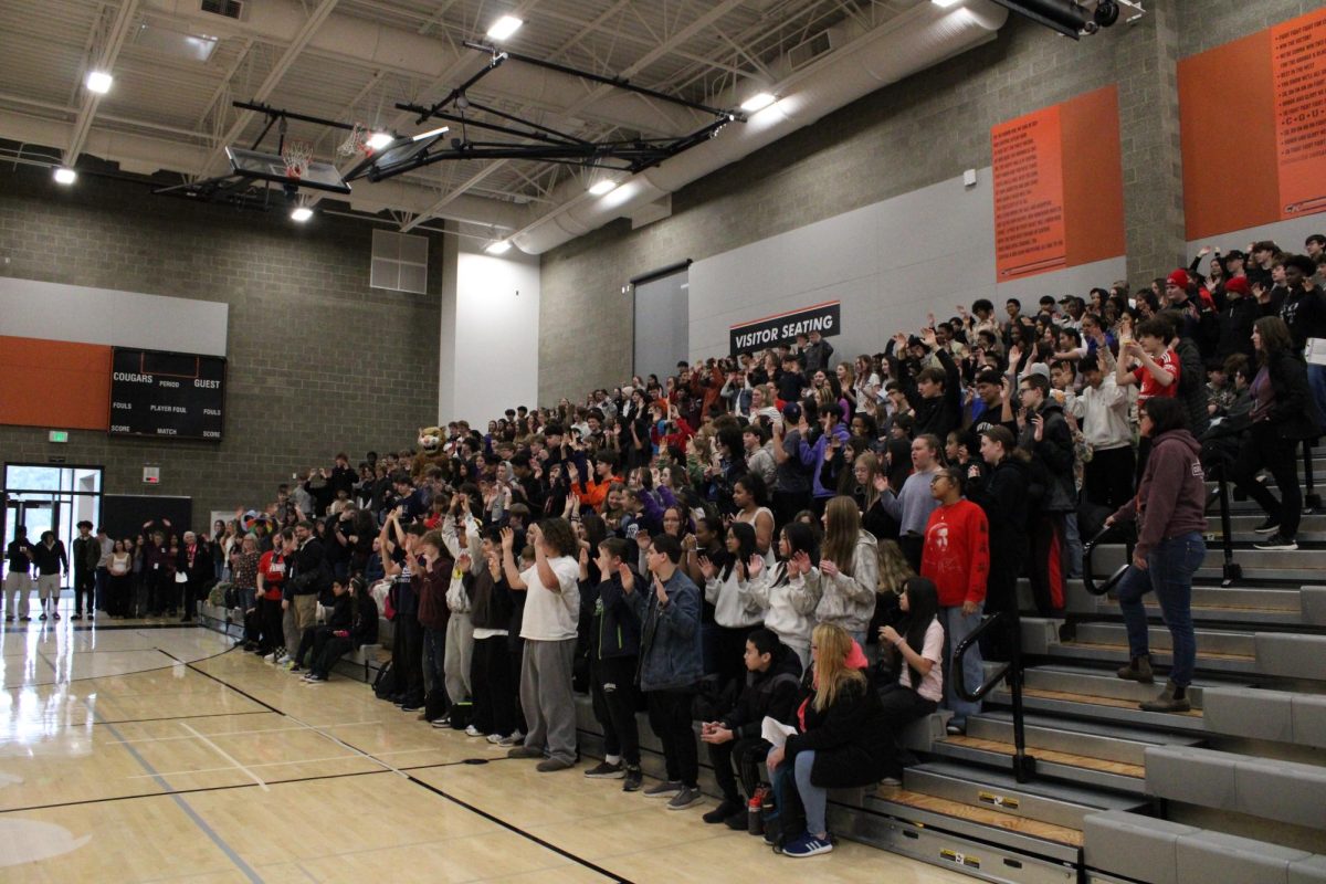 Eighth grade students fill the gym, waiting for the tour to start.