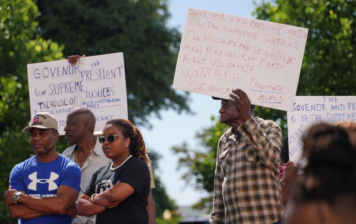 People display signs as they attend a rally over voting rights and redistricting outside the state capitol in Montgomery, Alabama, U.S. May 4, 2026.  REUTERS/Jayla Whitfield-Anderson